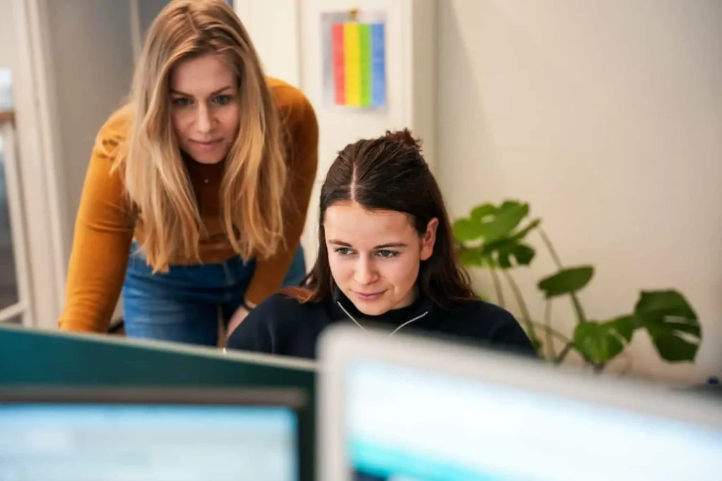 Twee collega's achter een computer